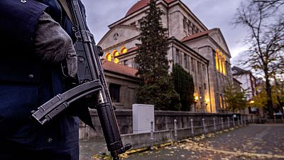 FILE -A German police officer stands guard in front of the synagogue in Frankfurt, Germany, early Wednesday, Nov. 8, 2023
