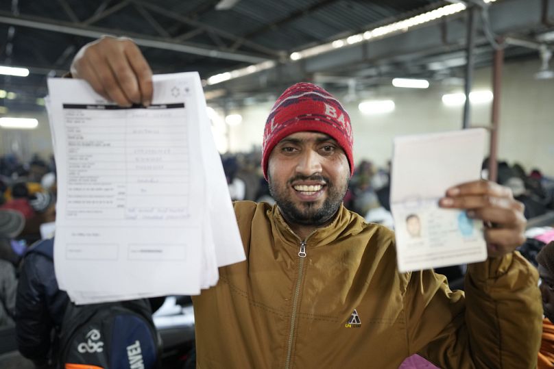 Anup Singh, an Indian skilled worker aspiring to be hired for a job in Israel shows his passport and a form he filled during a recruitment drive in Lucknow, India, Thursday.