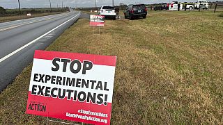 Anti-death penalty activists place signs along the road heading to Holman Correctional Facility in Atmore, Ala., ahead of the execution of Smith on Thursday.