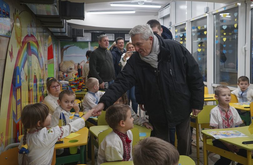United Nations High Commissioner for Refugees Filippo Grandi greets pupils as he visits a school in Kharkiv, Ukraine, Monday, Jan. 22, 2024.