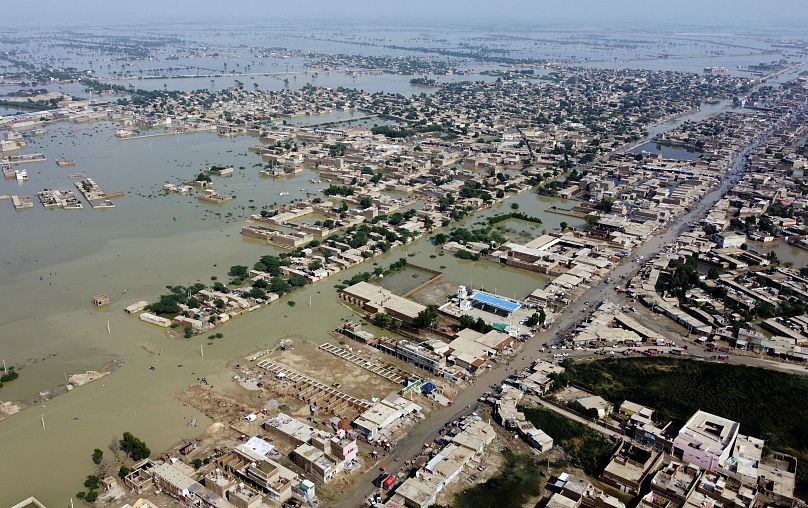 Homes are surrounded by floodwaters in Sohbat Pur city, a district of Pakistan's southwestern Baluchistan province, 30 August 2022.