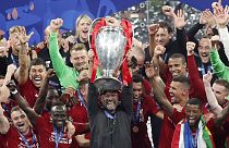 Liverpool coach Juergen Klopp lifts up the trophy as he celebrates with players after winning the Champions League final soccer match between Tottenham Hotspur and Liverpool 
