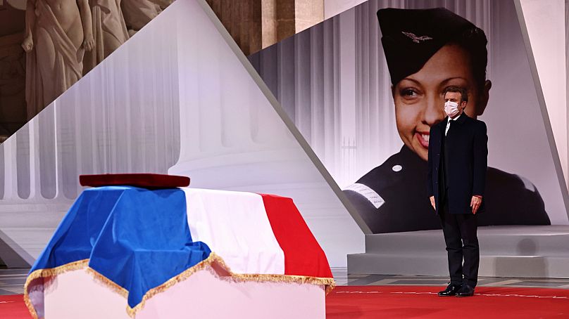 Emmanuel Macron pay respect to the cenotaph of Josephine Baker, covered with the French flag, at the Pantheon in Paris, France, Tuesday, Nov. 30, 2021