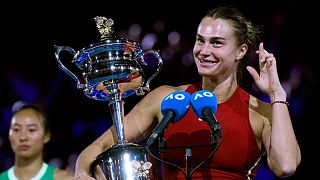 Aryna Sabalenka of Belarus holds the Daphne Akhurst Memorial Cup after winning Australian Open, 27 January 2024