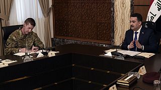 Iraqi Prime Minister Mohammed Shia al Sudani (R) and Major General Joel "J.B." Vowell attend the first round of the negotiations between Iraq and the US in Baghdad on Saturday