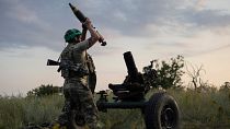 FILE - A Ukrainian serviceman of the 3rd Assault Brigade fires a 122mm mortar towards Russian positions at the front line, near Bakhmut, Ukraine, July 2023