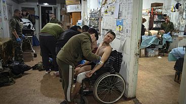 Military medics give first aid to wounded Ukrainian soldiers at a medical stabilization point near Bakhmut, Donetsk region in Ukraine
