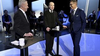 Presidential candidates Pekka Haavisto left, Jussi Halla-aho, center, and Alexander Stubb speak before the debate at Yle in Helsinki on January 25, 2024.