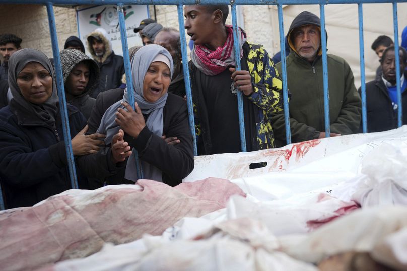 Palestinians mourn the relatives killed in the Israeli air and ground offensive on the Gaza Strip at a hospital in Deir al Balah on Friday.