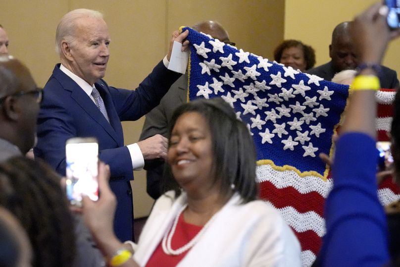 President Joe Biden holds up a hand-made flag gifted by a supporter.