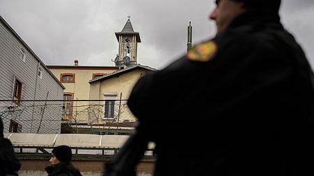 Turkish police officers stand guard in a cordoned off area outside the Santa Maria church, in Istanbul, Turkey, Sunday, Jan. 28, 2024. 