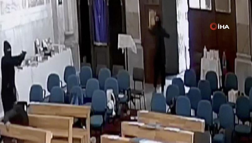 A screenshoot from video footage taken from a CCTV camera, shows two masked men holding guns inside Santa Maria church in Istanbul, Turkey, Sunday, Jan. 28, 2024.
