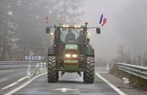 A farmer drives his tractor on a highway, near Agen, southwestern France, 27 January 2024. 