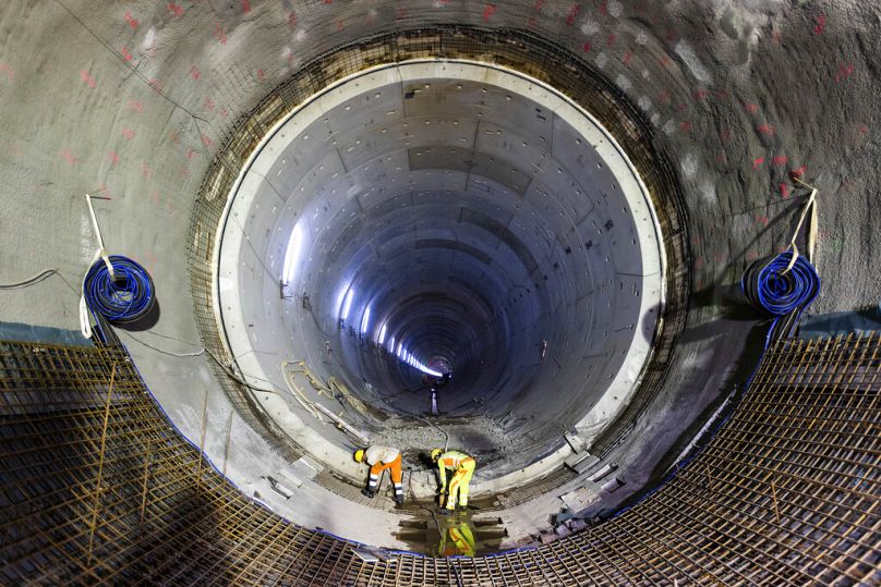 Two craftsmen work at the construction site of a new rail tunnel in Rastatt, August 2022