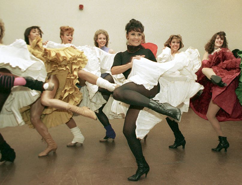 Chita Rivera, foreground, and the Radio City Music Hall Rockettes rehearse Cole Porter's "Can Can" in New York on 21 Jan. 1988.