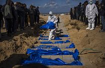 Palestinians bury the bodies of people who were killed in fighting with Israel and returned to Gaza by the Israeli military, during a mass funeral in Rafah, Gaza Strip.