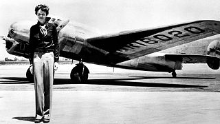 Amelia Earhart with her iconic Lockheed Electric aircraft in which she disappeared attempting to circumnavigate the globe in July 1937.