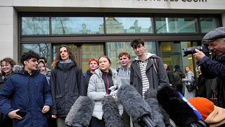 Environmental activist Greta Thunberg, centre, speaks to the media at Westminster Magistrates Court.