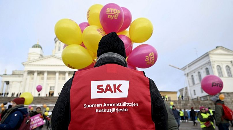 A man wearing a red vest of the Central Organisation of Finnish Trade Unions (SAK) takes part in the Stop Now! demonstration against Finland's government's labour market polic