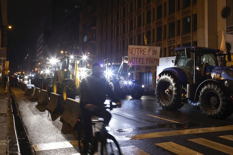 Tractors are parked as farmers gather for a protest near the European Council headquarters ahead of an EU summit in Brussels.