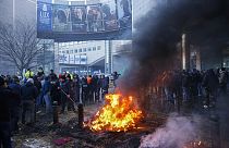 Farmers burn straw and tyres during a protest outside the European Parliament as European leaders meet for an EU summit in Brussels, Thursday, Feb. 1,