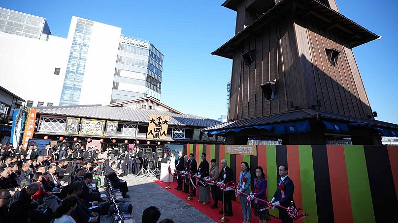 Guests attend the ribbon cutting ceremony of newly opened "Toyosu Senkyaku Banrai," an Edo Period-themed hot spring complex on opening day at Toyosu Fish Market, Feb. 1, 2024