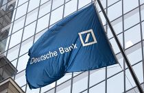 A flag for Deutsche Bank flies outside the German bank's New York offices on Wall Street. Oct. 7, 2016.
