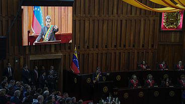 Venezuelan President Nicolas Maduro's live video image plays on monitors as he speaks during a ceremony marking the new judicial year at the Supreme Court in Caracas