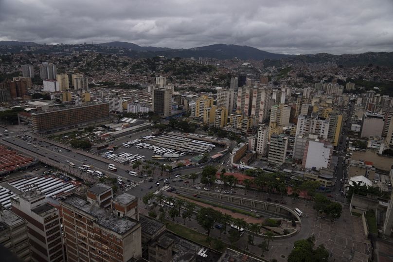 Cars circulate along Bolivar Avenue past La Bandera bus terminal in downtown Caracas, Venezuela.