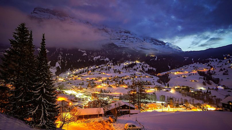 A night time view of Grindelwald Switzerland with mount Eiger in the background.