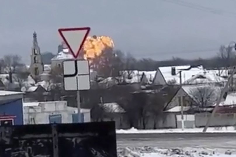In this handout photo taken from validated UGC video show flames rising from the scene of a warplane crashed at a residential area near Yablonovo, 31 January 2024
