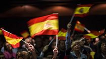 In this Wednesday, Nov. 14, 2018 photo, supporters of Spain's far-right Vox party, wave flags during a rally in Murcia, Spain. 