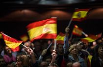 In this Wednesday, Nov. 14, 2018 photo, supporters of Spain's far-right Vox party, wave flags during a rally in Murcia, Spain. 