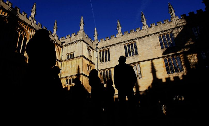 People are silhouetted in the Old Schools Quadrangle, Old Bodleian Library first opened to scholars in 1602 at Oxford University in Oxford, October 2008