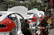 Cars move through the assembly line at Tesla Motors, California's only full-scale auto manufacturing plant
