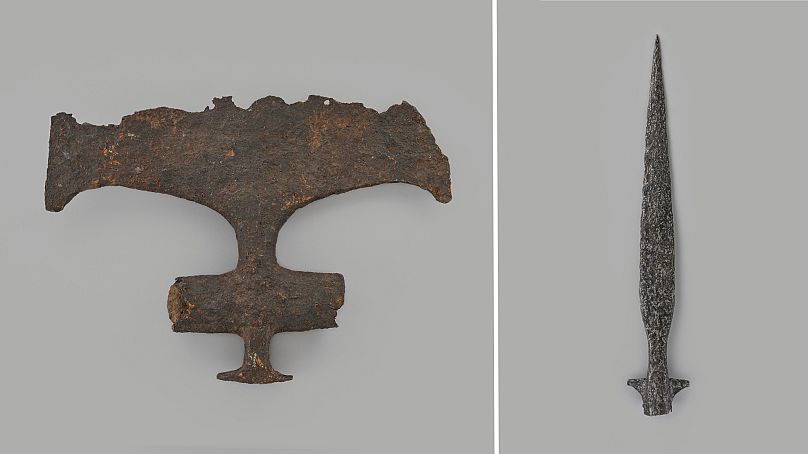 A battle axe (left) and spear found in the Seine.