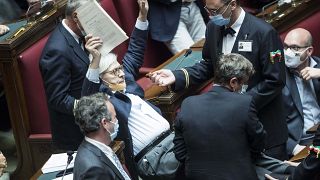Vittorio Sgarbi resigns - pictured here being carried out of the Chamber of Deputies by parliamentary assistants after arguing with other lawmakers
