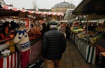 People shop at an open air market in Fontainebleau, south of Paris, France.