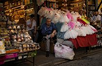 Sellers wait for clients in a street market in Istanbul, Turkey, Wednesday, Sept. 6, 2023. 