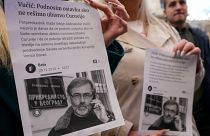 Media rights groups and opposition campaigners hold leaflets showing journalist Slavko Curuvija during a protest in front of Serbian appeals court, in Belgrade, Serbia
