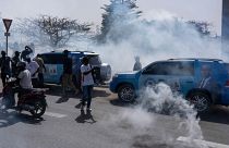 Senegalese riot police lob tear gas at supporters of opposition presidential candidate Daouda Ndiaye.