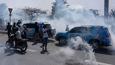 Senegalese riot police lob tear gas at supporters of opposition presidential candidate Daouda Ndiaye.