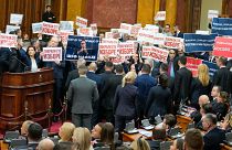 Opposition lawmakers hold banners reading: "Stole the elections" during a Serbia's parliament constitutive session in Belgrade, Serbia, Tuesday, Feb. 6, 2024. 