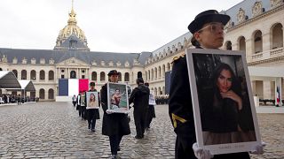 La Guardia Republicana francesa camina con retratos de las víctimas francesas del ataque de Hamás del 7 de octubre de 2023, durante una ceremonia el 7 de febrero de 2024.