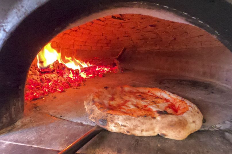 Solo pizza? Why not! Pizza is cooked in a wood oven at the Caputo pizzeria in Naples, Italy