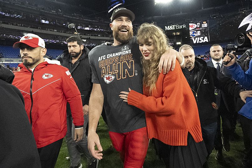 Travis Kelce and Taylor Swift walk together after an AFC Championship NFL football game between the Kansas City Chiefs and the Baltimore Ravens, Sunday, Jan. 28, 2024