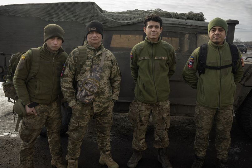 Colombian veterans who joined the Ukrainian armed forces to help fight Russia pose for a photo near their Humvee on the front line near Lyman, Donetsk region, Ukraine, Monday.