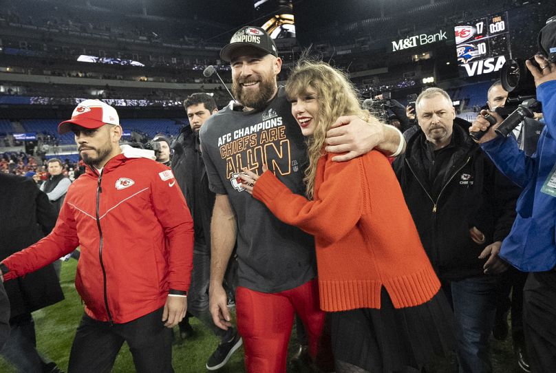 Kansas City Chiefs player Travis Kelce and Taylor Swift walk together after an AFC Championship NFL football game between the Chiefs and the Baltimore Ravens last month