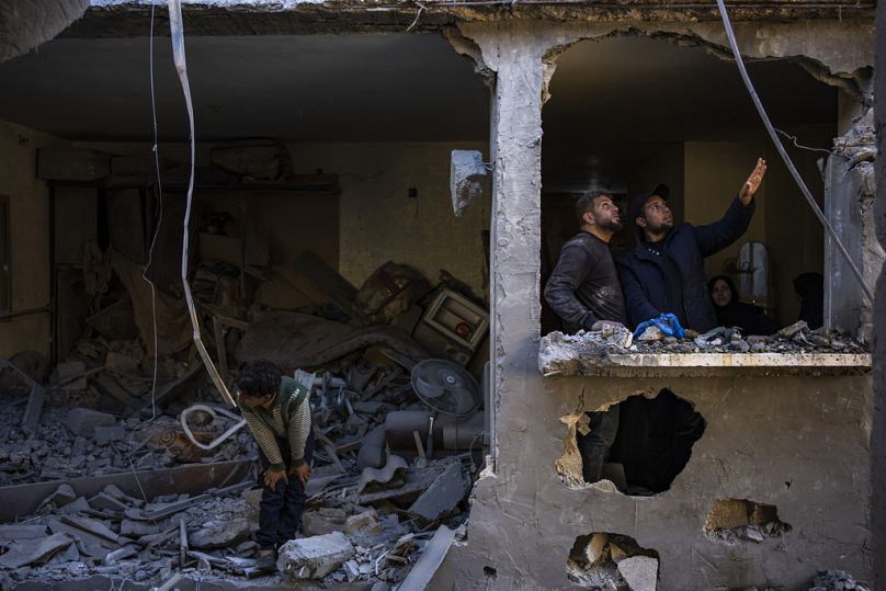 Palestinians look at the destruction after an Israeli strike in Rafah, southern Gaza Strip, Thursday, Feb. 8, 2024.