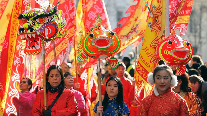 Люди в костюмах участвуют в параде в честь китайского нового года, года Собаки, в районе Чайнатаун в Лондоне